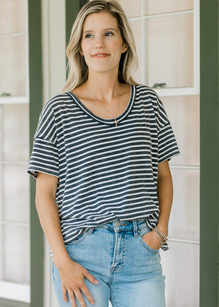 Close up of model wearing a navy and white striped tee with a scoop neck and short sleeve. 