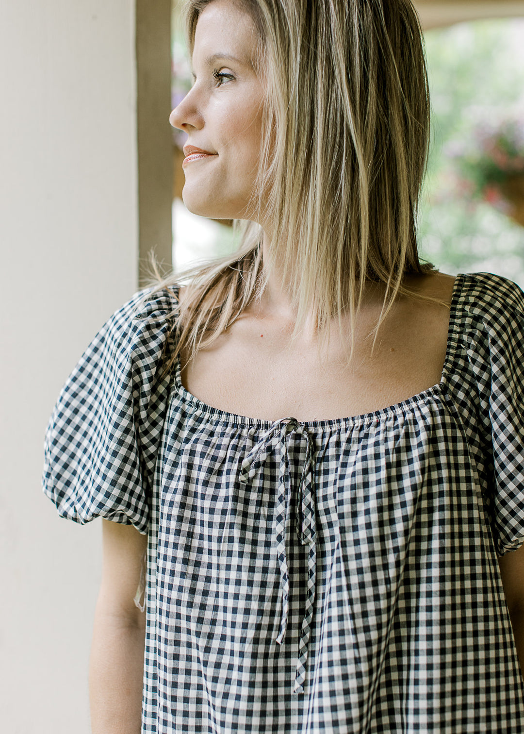 Bubble short sleeves and square neck on a navy and cream gingham above the knee dress. 