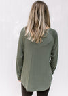 Back view of Model wearing an olive top with a round neck, long sleeves and a bamboo material.