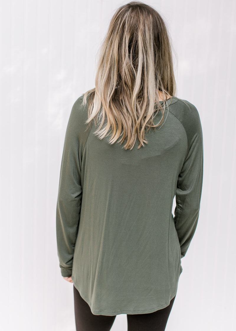Back view of Model wearing an olive top with a round neck, long sleeves and a bamboo material.