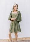 Model wearing an olive dress with eyelet detail, square neck and 3/4 bubble sleeves.