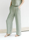 Close up of wide leg pants with an elastic waistband and pockets, part of a set, top is crop fit. 