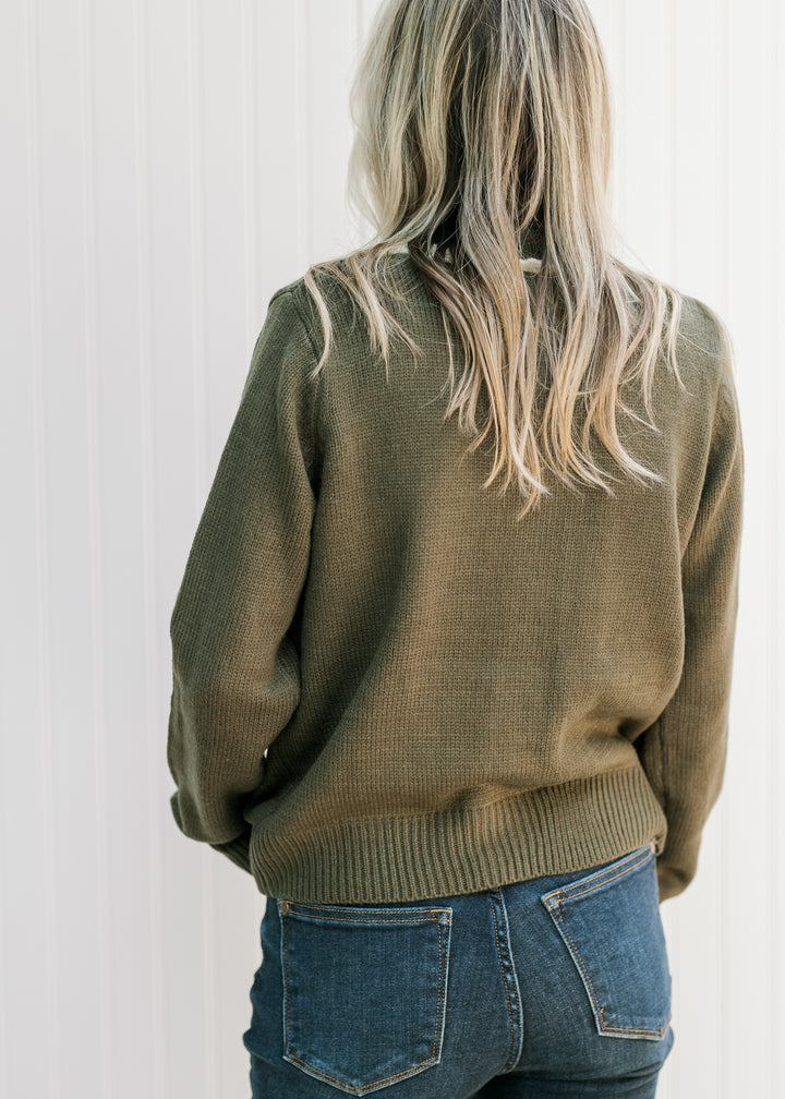 Back view of Model wearing an olive cardigan with a round neck and long sleeves. 