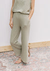 Close up of light olive wide leg pant with pockets and an elastic waist, with matching top