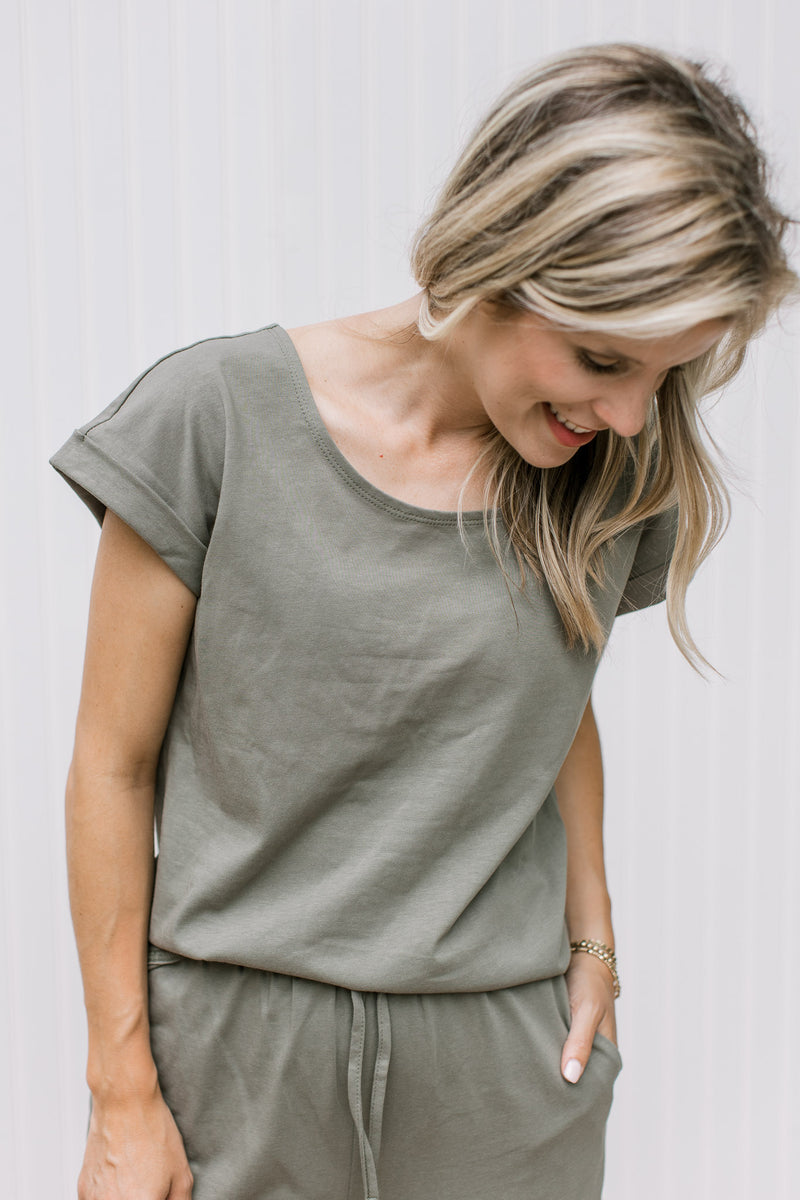 Close up of olive top with a round neck and cuff sleeves with matching wide leg pants.