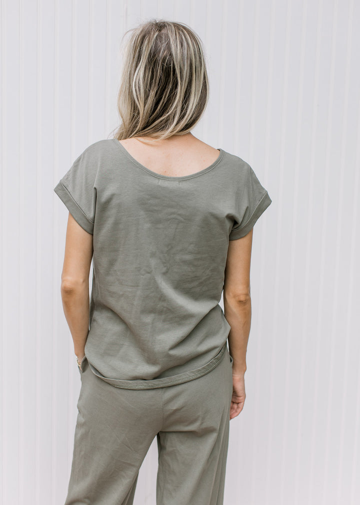 Back view of olive top with round neck and cuff sleeves with wide leg matching pants.