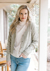 Model wearing jeans and a soft olive button up cardigan with scalloped edging, and long sleeves.