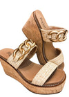 Side view of sandals with a double raffia strap, gold chain detail and cork wedge heel. 