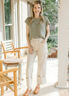 Model wearing khaki’s, mules and a pale sage knit sweater with capped sleeve and a round neck. 