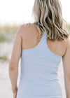 Back view of model wearing a light blue racer back tank. 