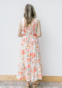 Back view of Model wearing a cream, square neck maxi with smocked back and bright ric-rac trim. 