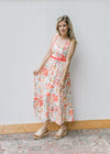 Model wearing wedges and a cream, square neck maxi with fruit, pots and treats and ric-rac trim. 