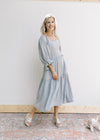 Model wearing wedges with a blue dress with pink flowers, smocked bodice and 3/4 sleeves.