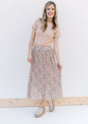 Model wearing a pleated, fully lined, floral skirt with mules and an oatmeal tee.  