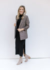 Model wearing a black maxi with a brown plaid blazer with 3/4 tacked sleeves and classic detailing. 