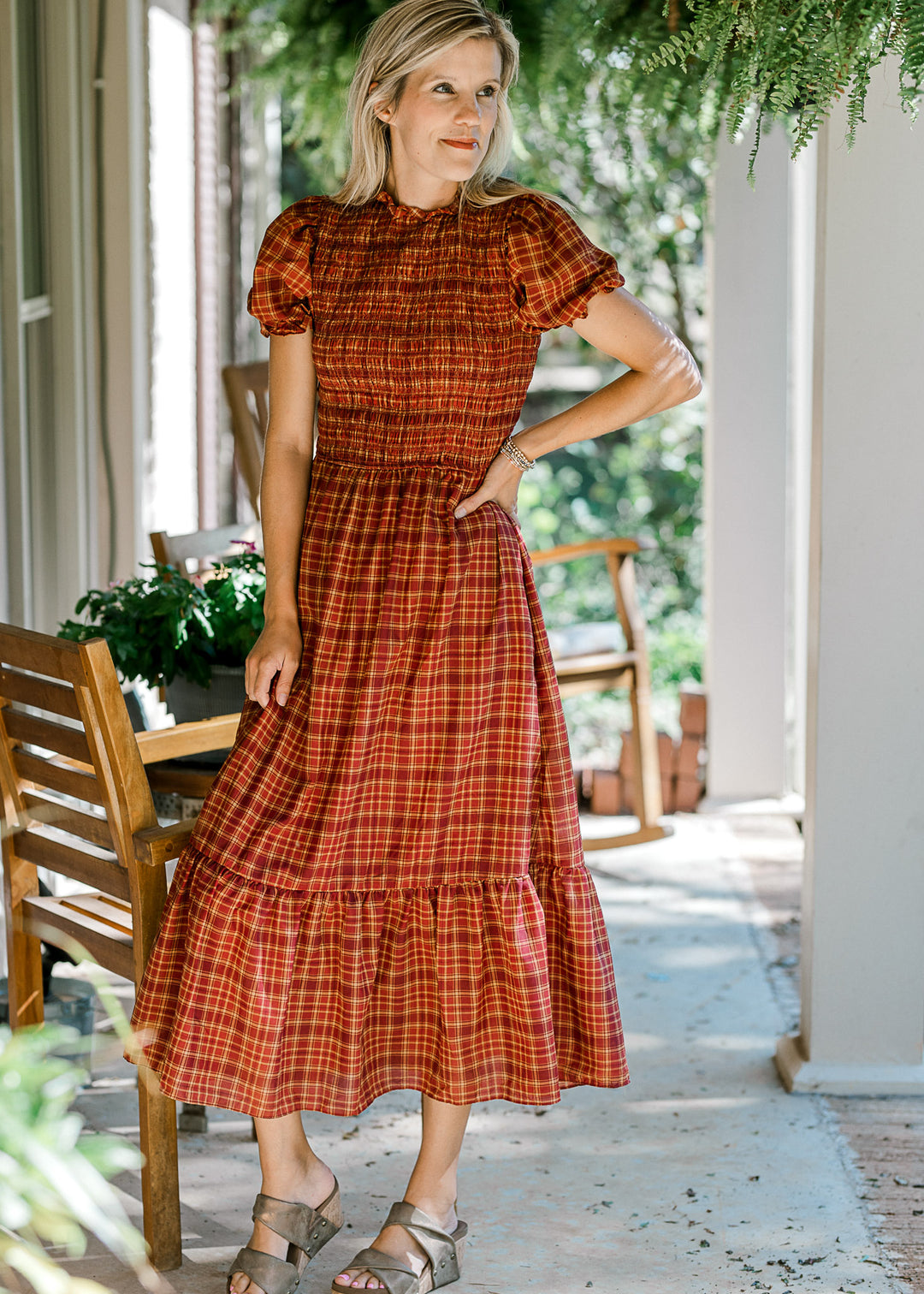 Model wearing sandals and a fall plaid midi with a smocked bodice and bubble short sleeves. 