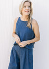 Close up of denim blue top with spaghetti straps and a slightly cropped fit, has matching bottoms.