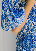 Close up of short bubble sleeves on a blue and white porcelain pattern dress. 