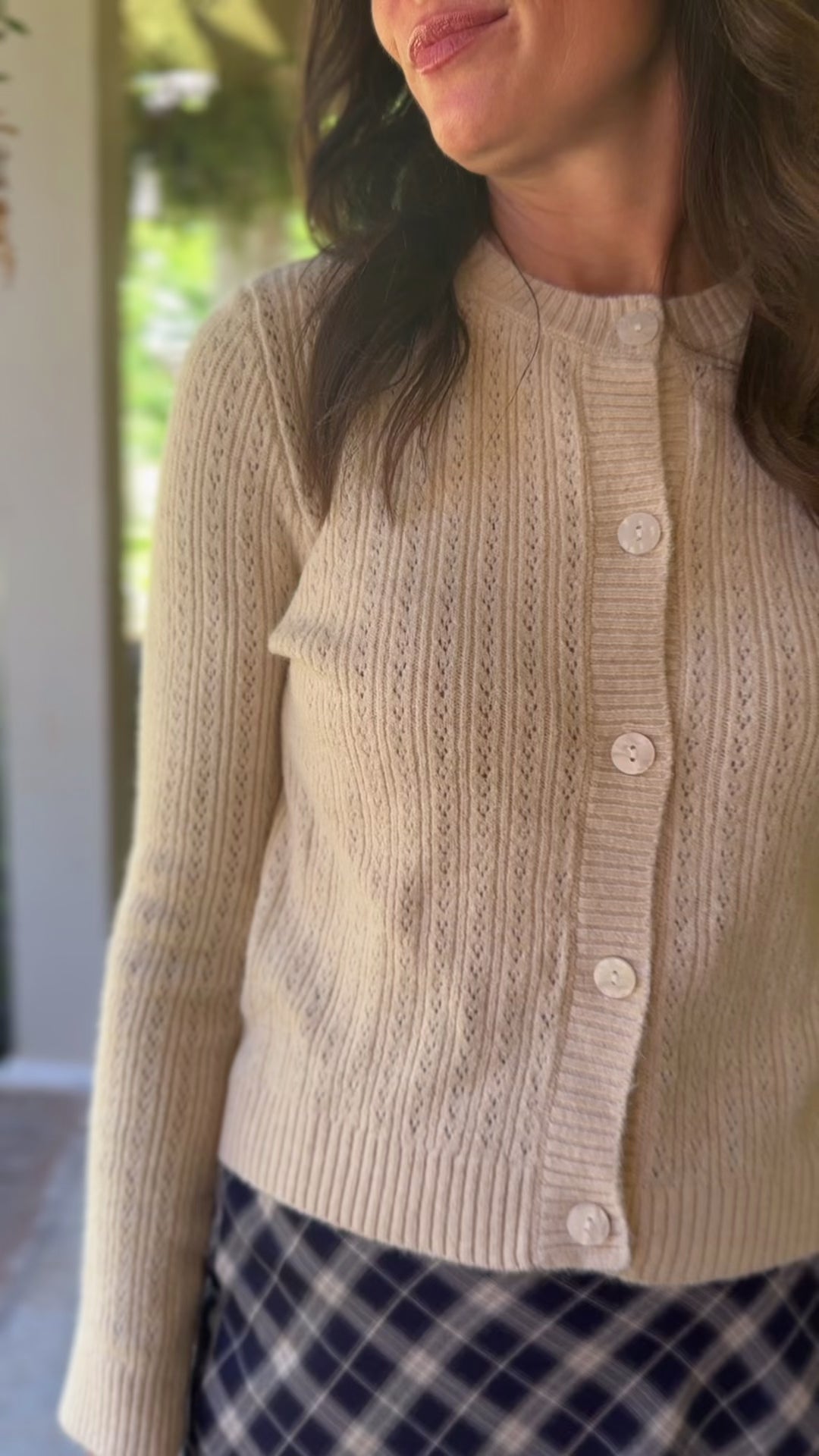 Video of Model wearing a lightweight navy and cream plaid maxi skirt with elastic back waistband. 