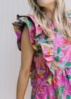 Close up of layered ruffle sleeveless dress on a lilac dress with bright floral. 