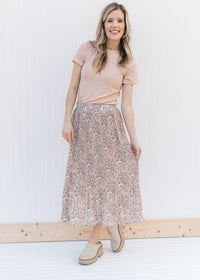 Model wearing a floral skirt with a ribbed oatmeal colored top with short sleeves and a round neck.