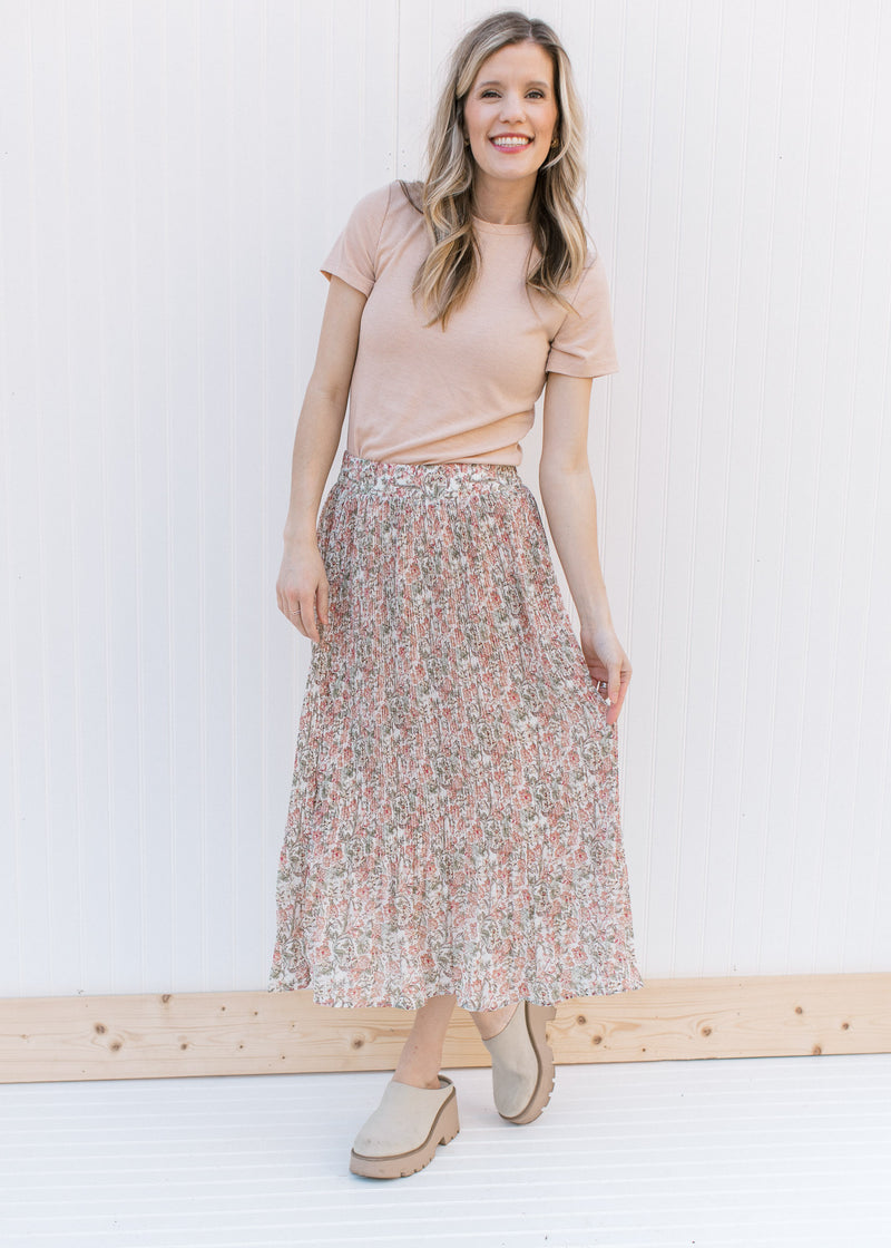 Model wearing a floral skirt with a ribbed oatmeal colored top with short sleeves and a round neck.