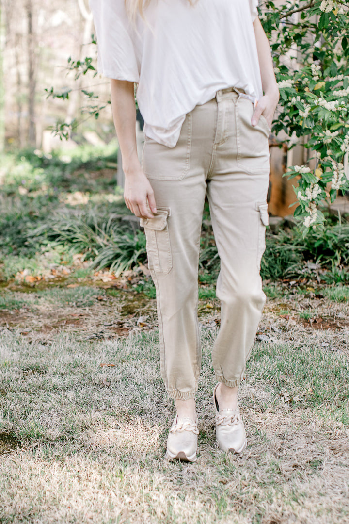 Model wearing a tee and cargo joggers with a soft taupe color, comprised of cotton and spandex.