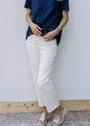 Model wearing cream midrise, straight pants with a cropped fit. 