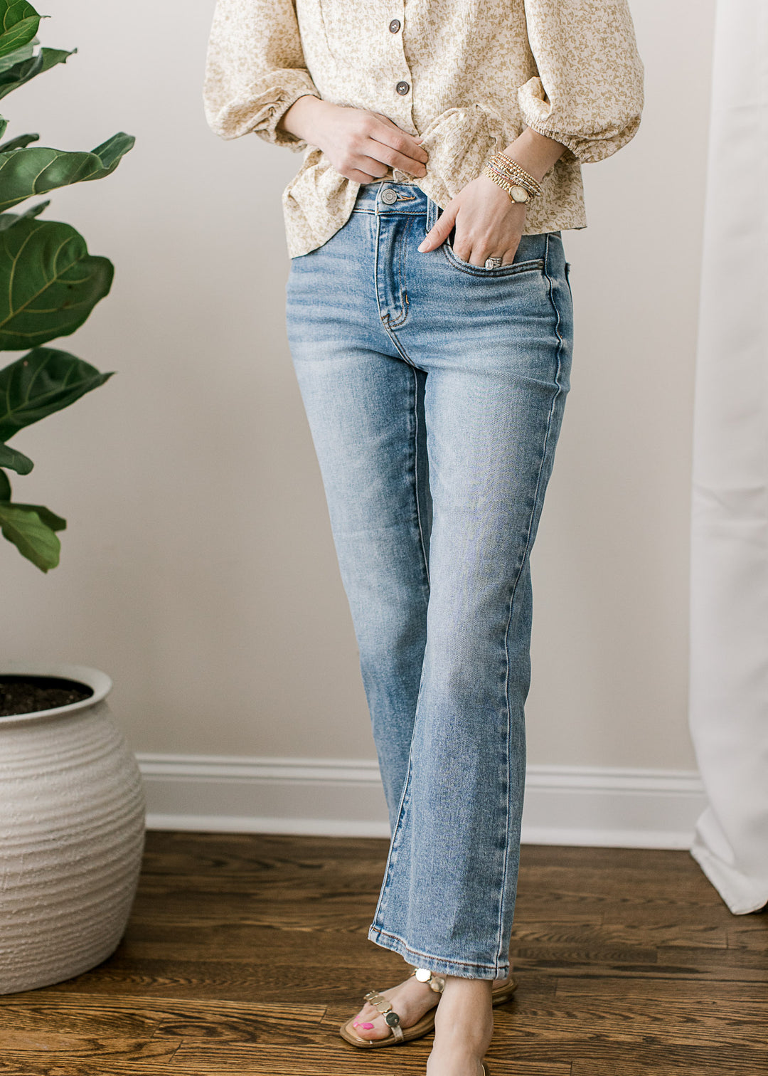 Model wearing medium wash jeans with a mid rise, cropped kick flare fit and a comfortable stretch.