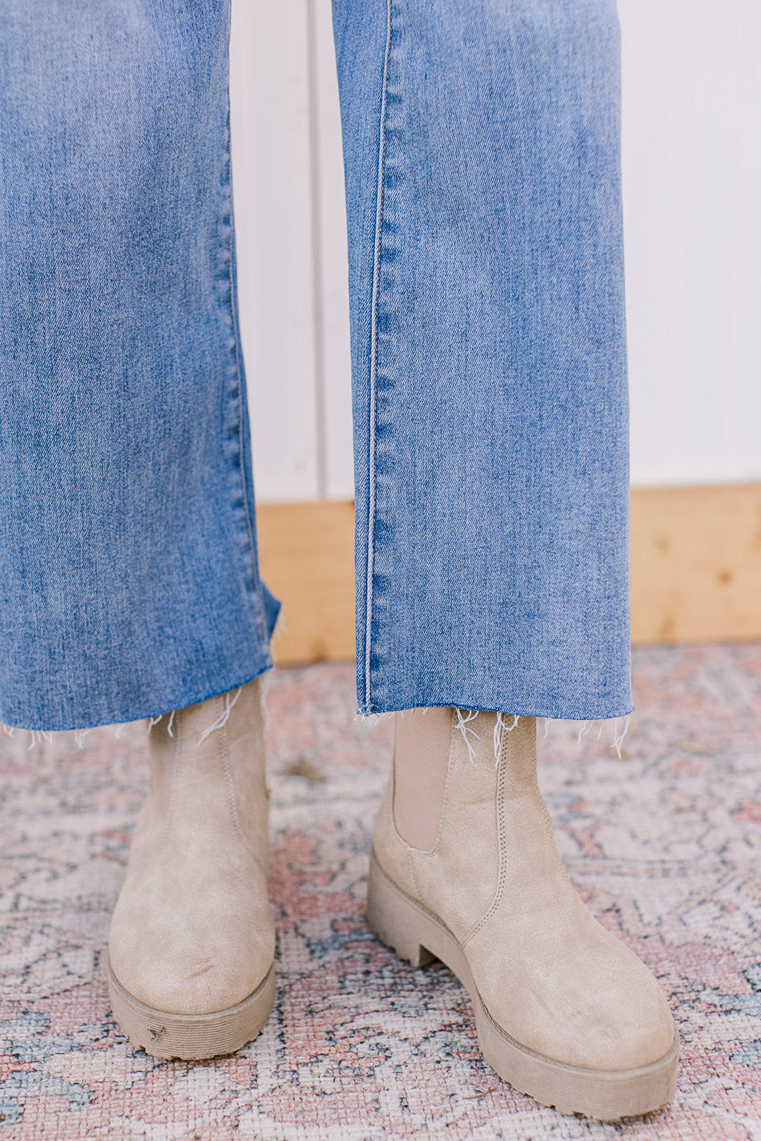 Close up of cut your own hem on medium wash jeans with soft waistband, wide leg and mid rise fit. 