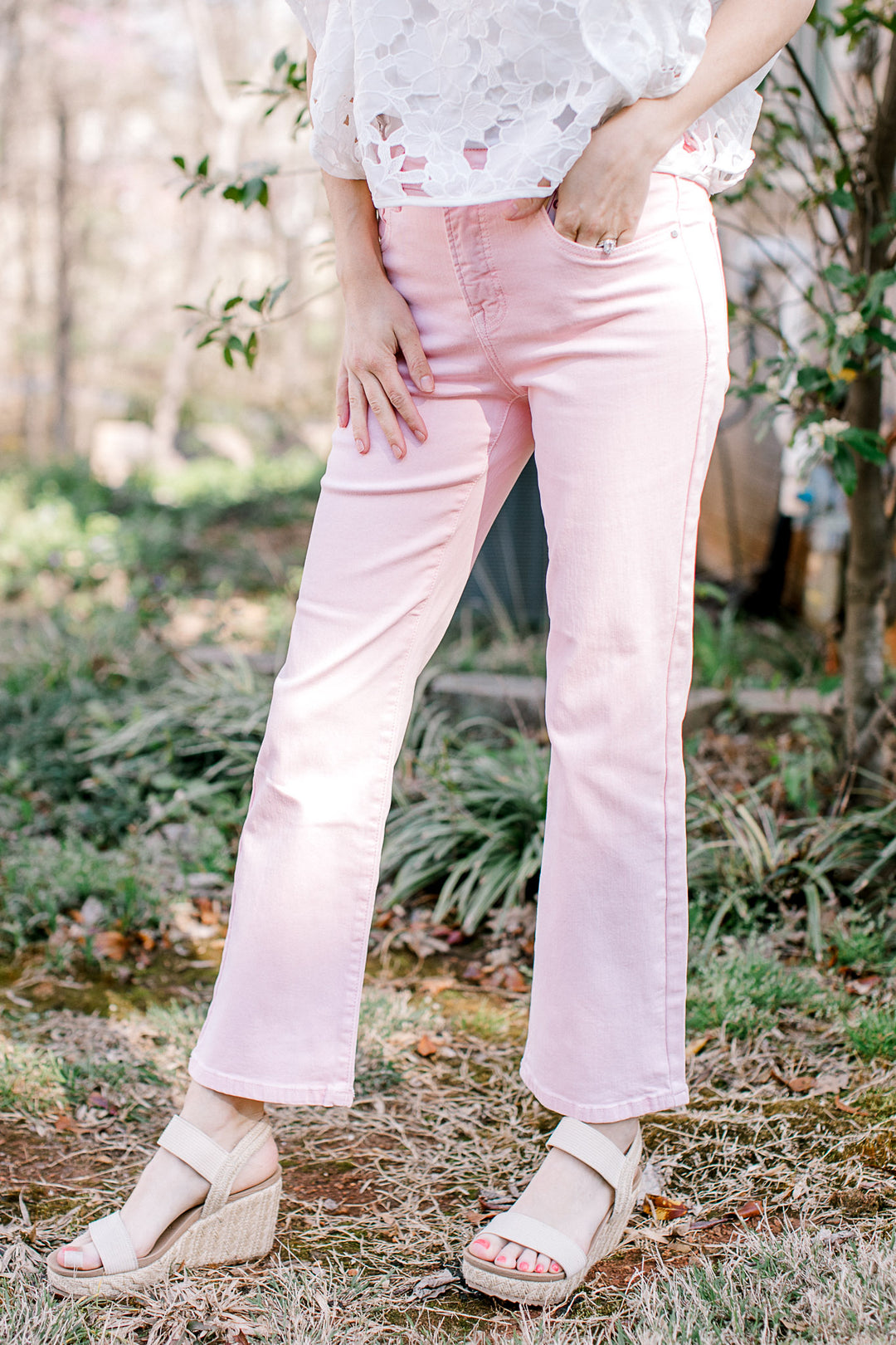 Model wearing cropped pale pink denim with tummy control and a straight leg fit. 