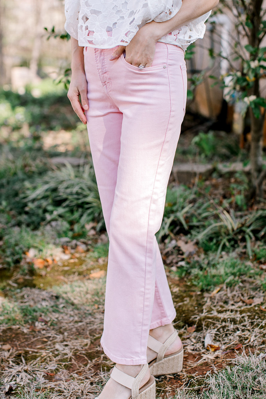 Model wearing sandals with a cropped pale pink denim with tummy control and a straight leg fit. 