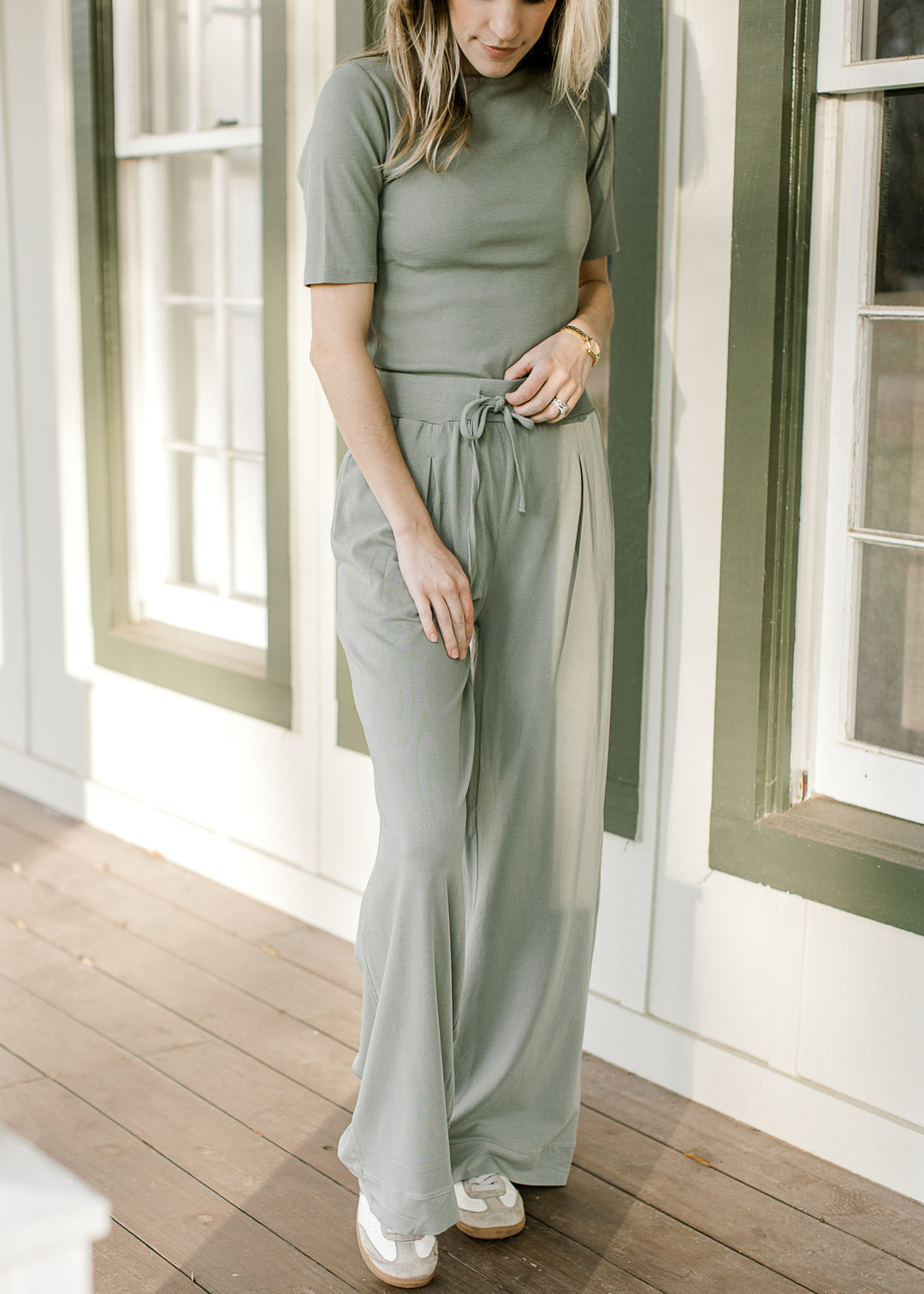 Close up of wide leg pants with tie elastic waist , pleating and pockets with a matching top. 