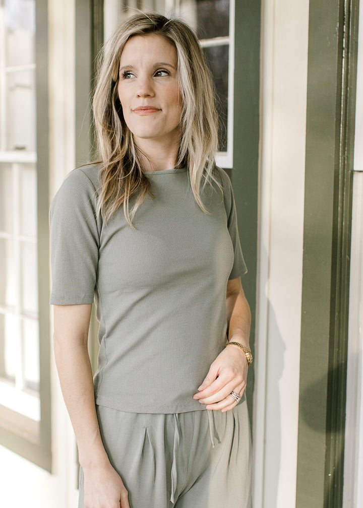 Close up of fitted ribbed short sleeve top and matching wide leg pants with elastic waistband. 