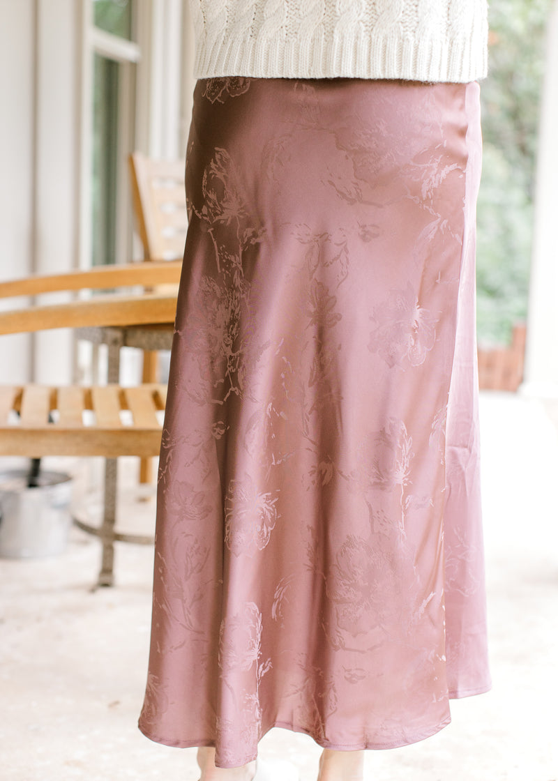 Back view of model wearing a chestnut maxi with a subtle floral pattern and satin material.