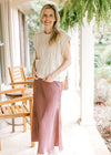 Model wearing a chestnut maxi with a cream cable knit sweater with capped short sleeves.