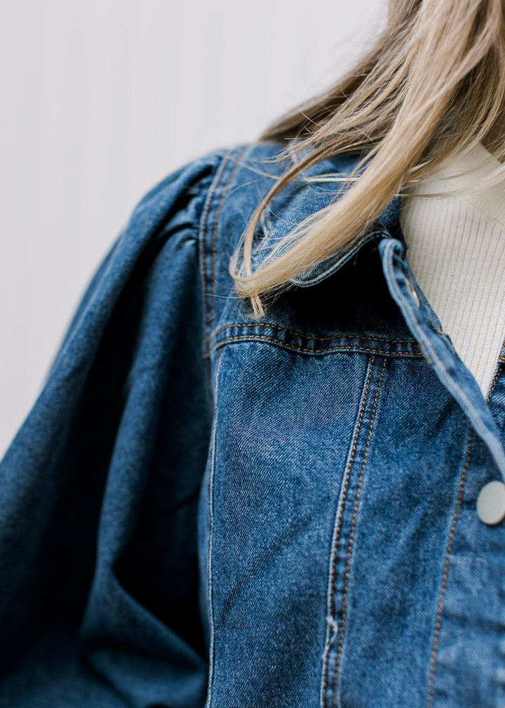 Close up of pleated shoulder and scalloped flap collar on a medium/dark wash jacket. 