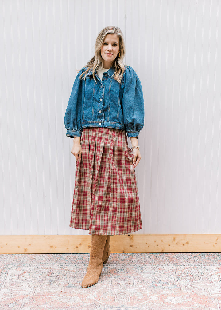 Model wearing plaid skirt and a medium/dark wash denim jacket with 3/4 bubble sleeves. 