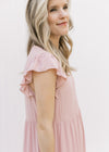 Close up of ruffle cap sleeve on a blush colored midi comprised of polyester. 