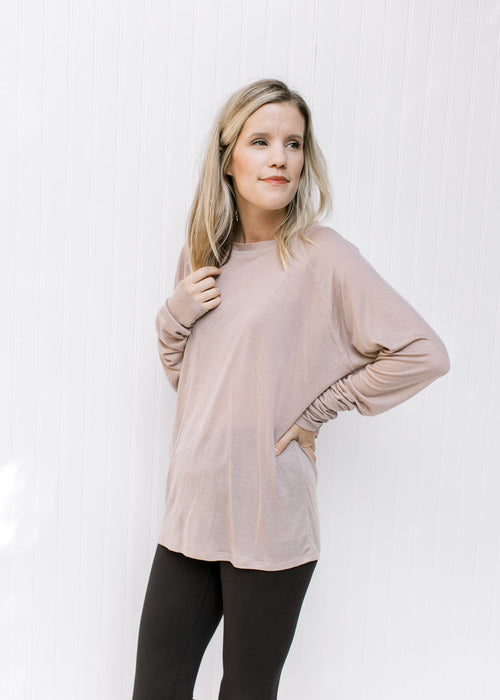 Model wearing a classic light purple long sleeve top with a round neck and a soft tencel material. 