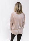 Back view of Model wearing a light purple long sleeve top with a round neck and a tencel material. 