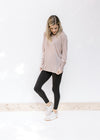 Model wearing black leggings with a light purple long sleeve top with a round neck and tencel. 