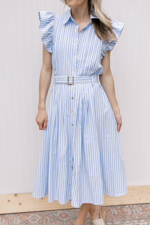 Model wearing a blue and white striped midi with flutter cap sleeves, button front and a belt. 