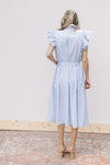 Back view of Model wearing a blue and white striped midi with flutter cap sleeves and a belt.