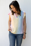 Model wearing a bright ombre top with a v-neck and flutter cap sleeves.