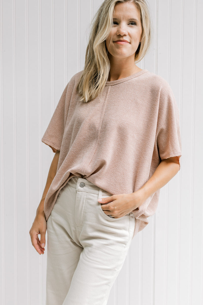 Model wearing a taupe lightweight sweater with a detail seam at the front, back and shoulder. 