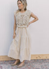 Model wearing a taupe maxi with cap sleeves, openwork crochet top and a tiered skirt. 