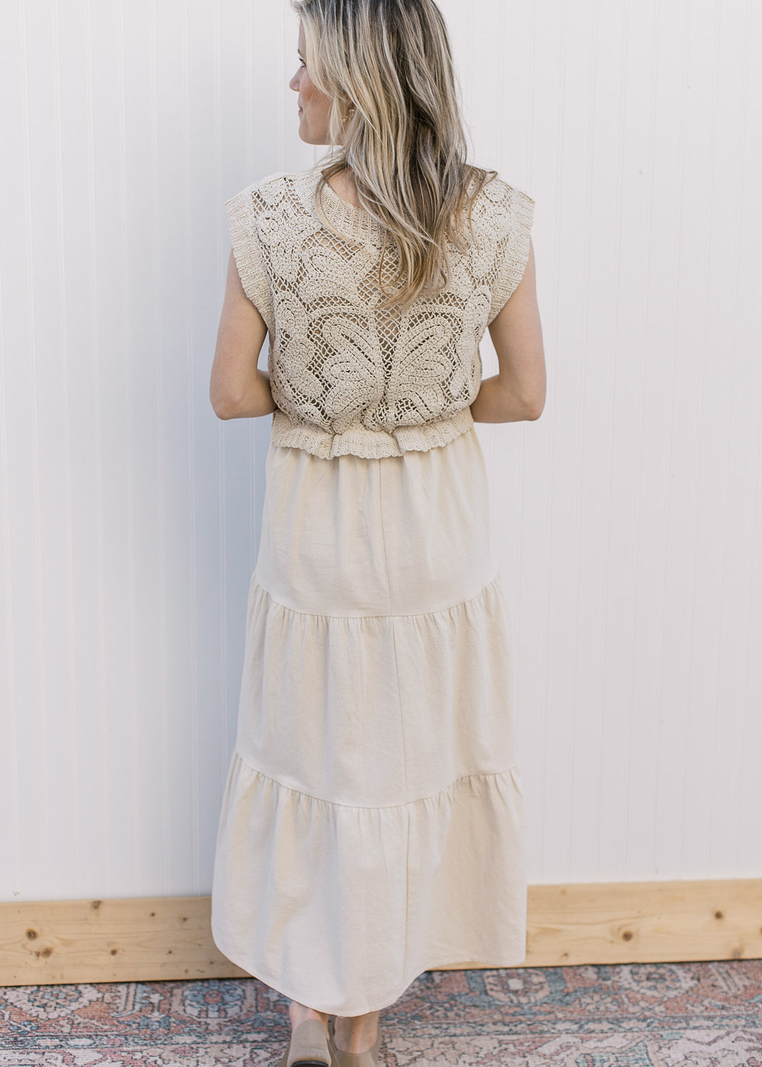 Back view of Model wearing a taupe maxi with a lined crochet top and capped sleeves. 