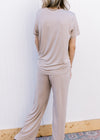 Back view of Model wearing a taupe set with a short sleeve crew neck top and wide leg bottoms.