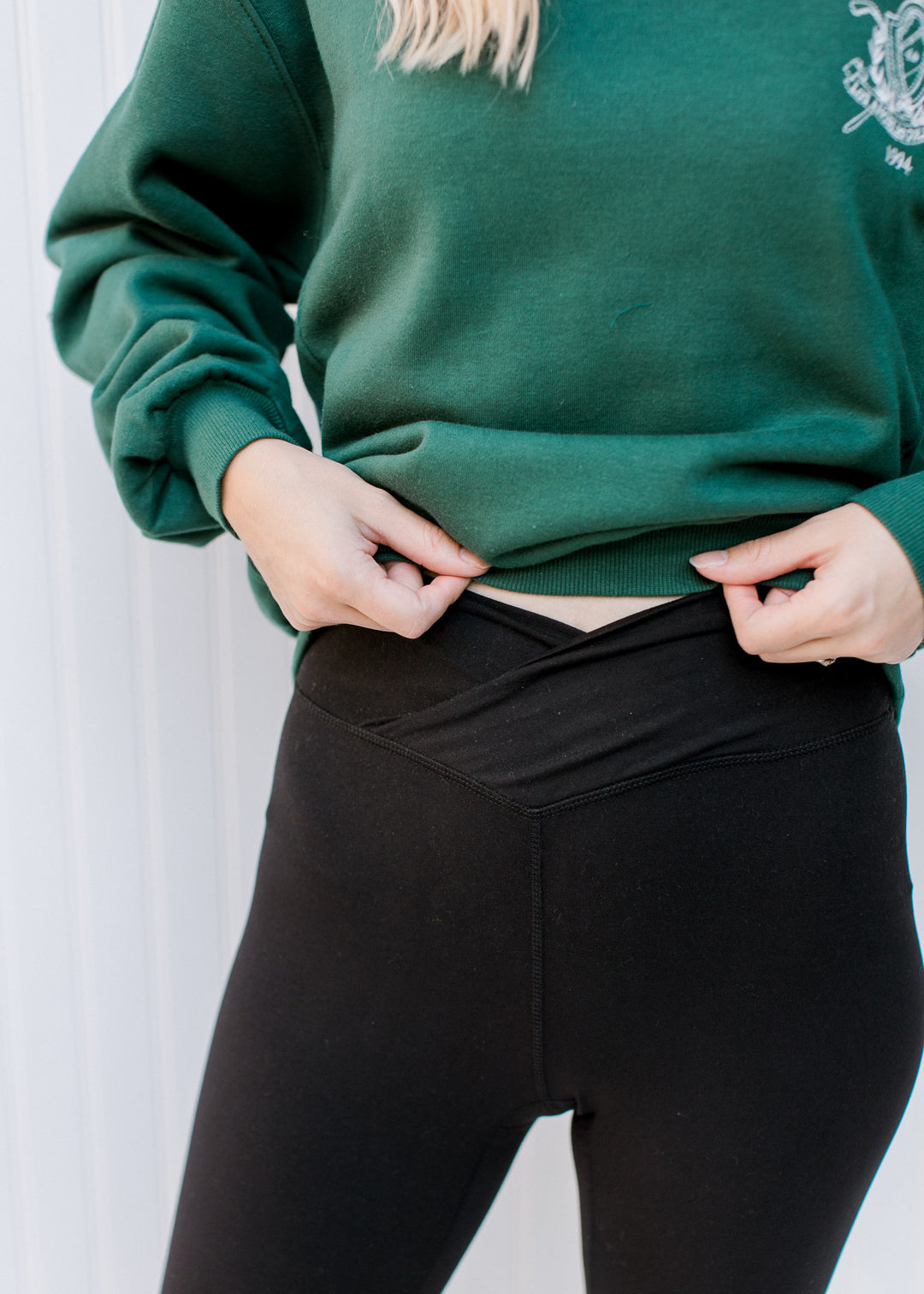 Close up of v-front on a model wearing black leggings. 